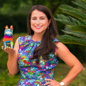 Laura Saldivar Luna poses for a photo with a pinata
