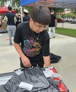 SAISD middle school students test cardboard boats during the district's first Cardboard Boat Regatta.