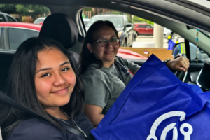 SAISD students receiving a free laptop from the SAISD Foundation